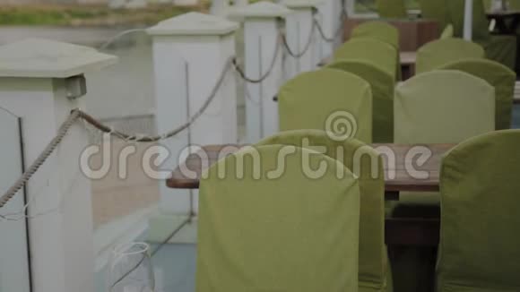 一个年轻人坐在露台餐厅的桌子旁视频的预览图
