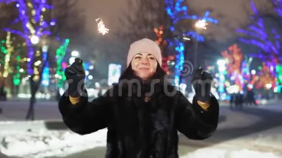 为庆祝圣诞节一位红头发的妇女在公园里挥舞孟加拉灯视频的预览图