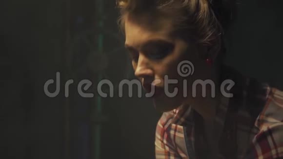 一位留着漂亮发型的疲惫的金发女郎下班后休息手里拿着扳手动作缓慢视频的预览图