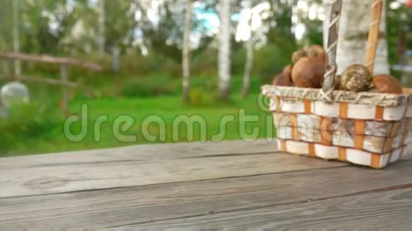蘑菇从桦木篮子里掉在木桌上视频的预览图