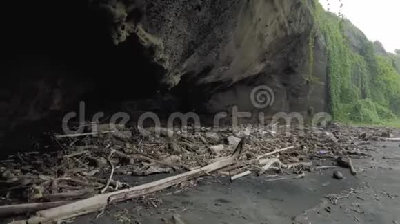 黑色巴厘岛海滩上的树木和垃圾残骸视频的预览图