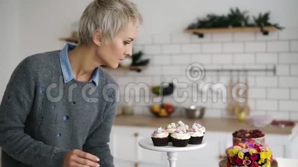 厨房里的女糖果里面有自制的松饼和蛋糕桌子上装饰得很漂亮的糕点慢动作视频的预览图