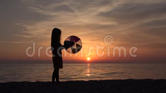 4K儿童肖像在日落时玩沙滩球海岸边的快乐女孩视频的预览图
