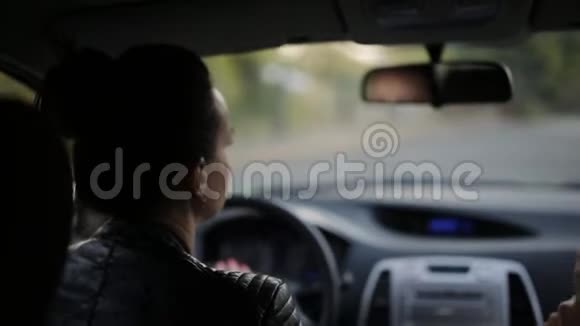 两个朋友开车旅行两个女人开车穿过马路视频的预览图