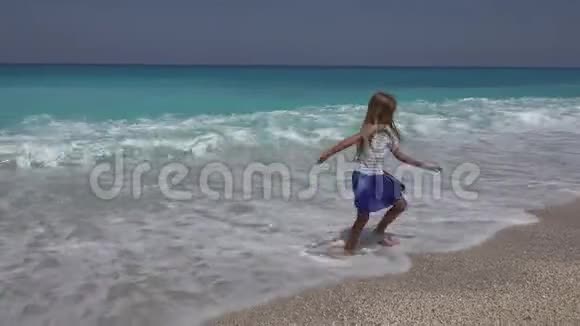 儿童在海滩玩耍观看海浪女孩在夏天的海岸线上旋转视频的预览图