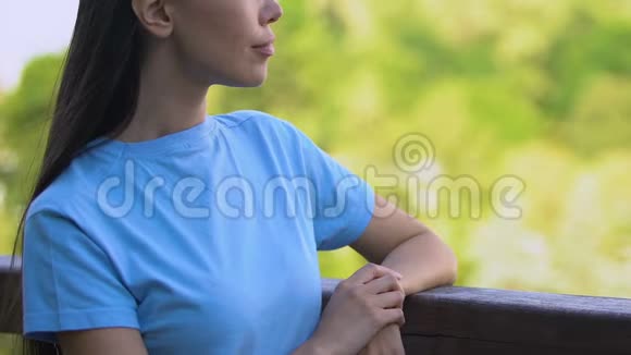 年轻女子站在露台上欣赏美丽的风景自然视频的预览图