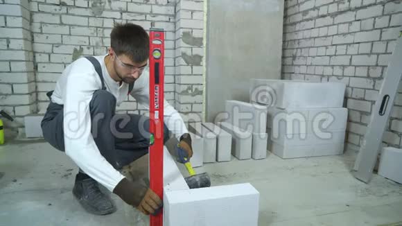 建筑工人按气泡水平铺设加气混凝土砌块视频的预览图