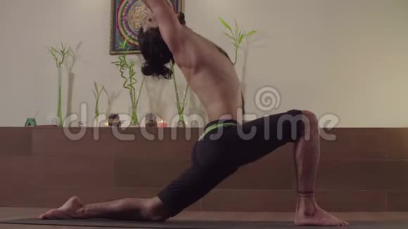 强壮的男人练习瑜伽英雄姿势三角姿势视频的预览图