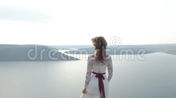 神奇而神秘的女孩从悬崖向海岸望去视频的预览图