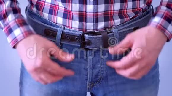 男人在摸牛仔裤上的皮带手特写视频的预览图