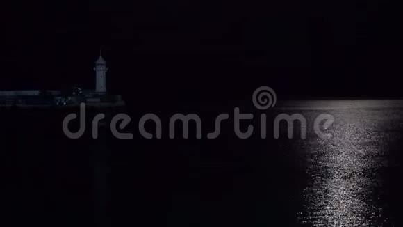 一座灯塔和一艘有着美丽灯光的月球小船视频的预览图
