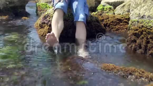 人脚被海浪冲刷用海水和漂浮的海藻采摘4k视频的预览图