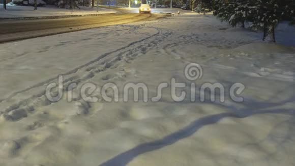雪覆盖农村道路汽车照明小径居民区视频的预览图