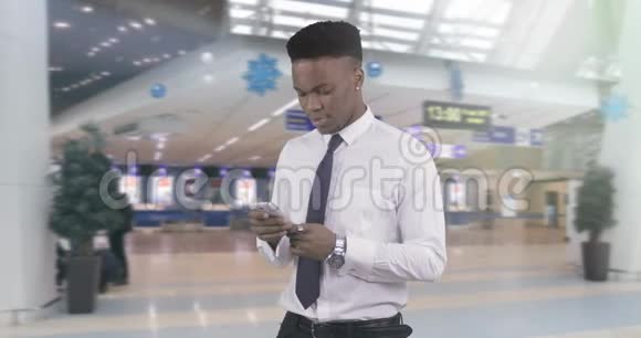 非裔美国人穿着白色衬衫的黑人在手机上读着留言视频的预览图