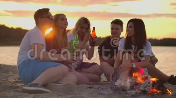 年轻人正在海滩上享受温暖的夏日夜晚视频的预览图