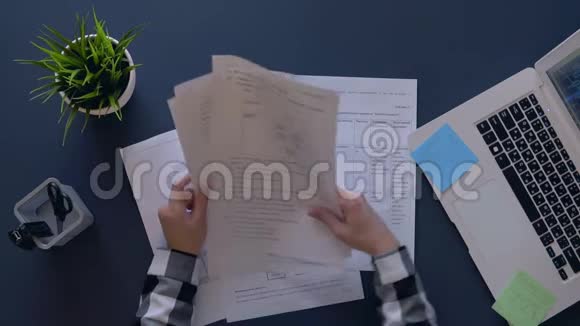 一个心情不好的女孩坐在桌子旁把文件扔起来抬起头来慢动作视频的预览图