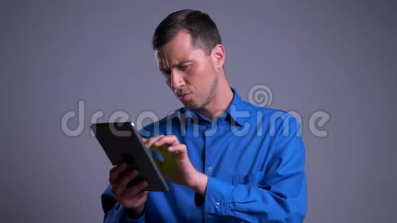成人兴奋的白种人在平板电脑上搜索的特写肖像放大显示绿色屏幕视频的预览图