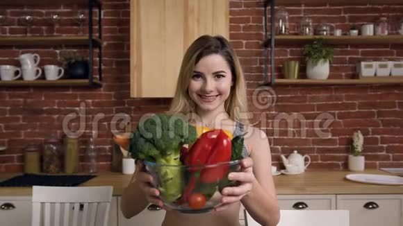 微笑的适合女孩的肖像提供蔬菜的菜肴视频的预览图