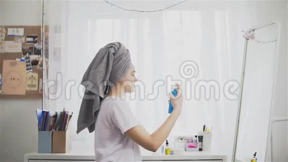 年轻女子用毛巾向脸上喷微水视频的预览图