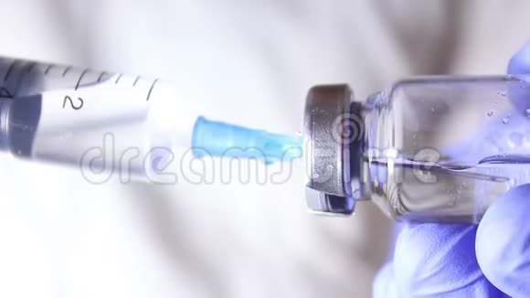 医生他的手把注射器装满疫苗为注射给病人做准备视频的预览图