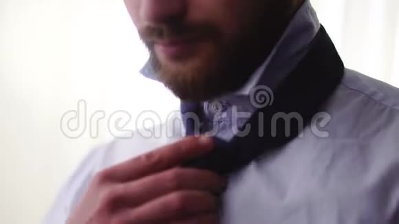 大胡子的人用手把领带系紧成人严肃绅士准备重要会议视频的预览图