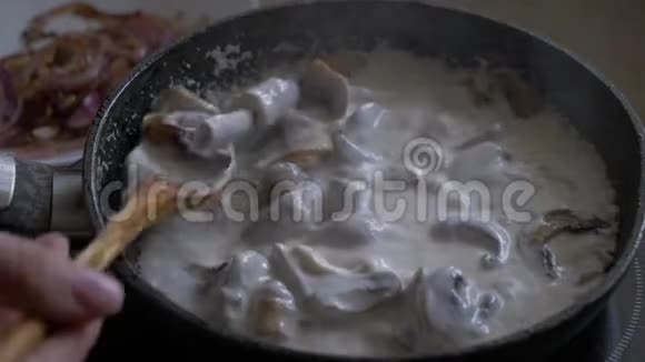 蘑菇是在平底锅里用奶油和混合的视频的预览图