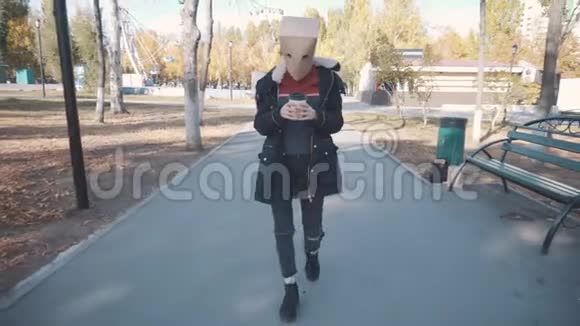 头上有个包裹的女孩拿着一杯咖啡走路穿夹克的女孩视频的预览图