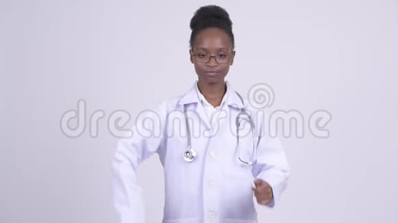 年轻迷茫的非洲女医生在竖起大拇指和大拇指之间做出选择视频的预览图