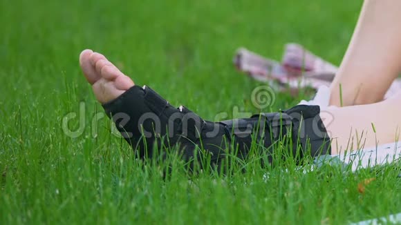 妇女在公园草地上行走的腿受伤后的康复视频的预览图