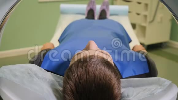 从CT机内部俯视男性患者进入CT扫描仪的特写镜头医疗设备计算机视频的预览图