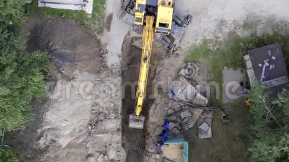 挖掘机和工人挖掘管道孔视频的预览图