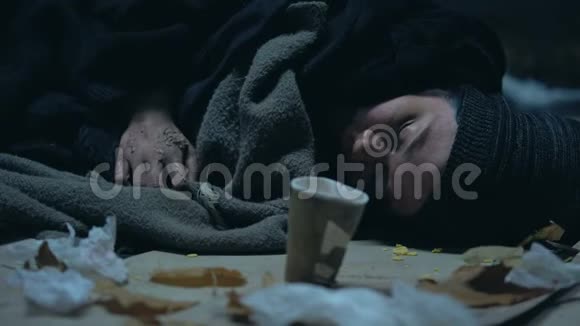 肮脏的乞丐睡在街上冻得发抖过路人捐钱视频的预览图