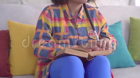 用手指合上一个有非洲发型的美国盲人女人在看书视频的预览图
