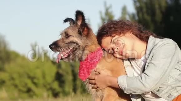 快乐的年轻白种人女人和她的狗在公园夏天视频的预览图