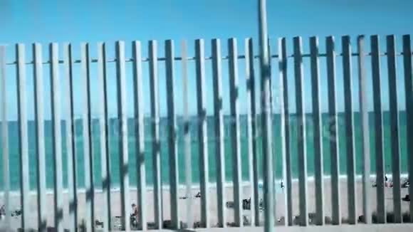 从火车的窗口眺望大海和海滩海滩是可见的槽栅栏视频的预览图
