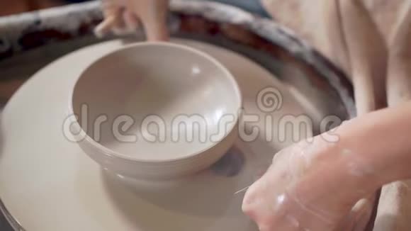 波特正从陶工的轮子上切割陶瓷碗特写镜头视频的预览图