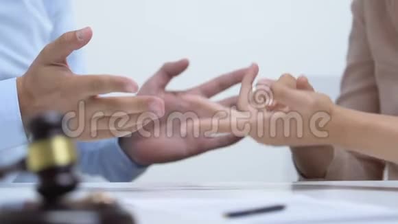 夫妻在法庭上争吵戴着订婚戒指的木槌离婚观念视频的预览图