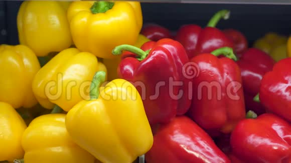 商店里有红辣椒和黄椒女人的手从超市的柜台上摘胡椒视频的预览图
