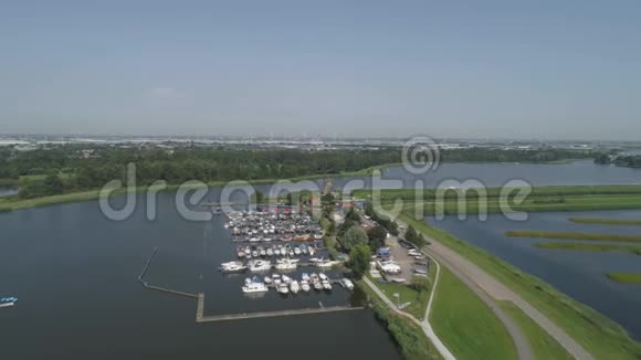 小码头有一个阳光明媚的天空和一个古老的荷兰传统风车位于鹿特丹附近的罗特梅伦湖视频的预览图