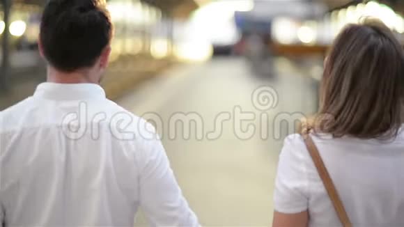 白种人有魅力的妻子和丈夫在火车站边走边走视频的预览图