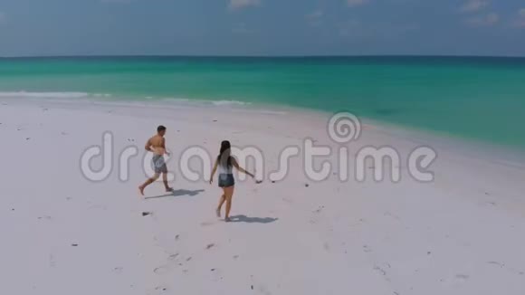 从上面看布格苏克岛上的蓬塔空中拍摄旅行情侣散步无尽的白色沙滩被绿松石包围视频的预览图