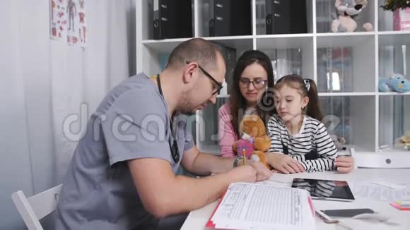 家庭医生开了一个小女孩的预约母亲和女儿在家庭医生的招待会上视频的预览图
