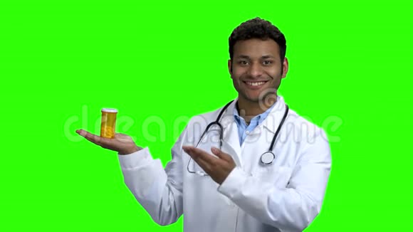 微笑的医生在绿色屏幕上呈现药丸视频的预览图