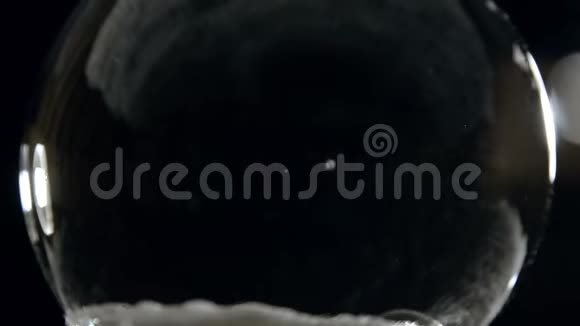 水晶球在黑色背景下慢慢凝固视频的预览图