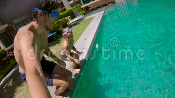 父子俩跳进游泳池的慢镜头视频的预览图