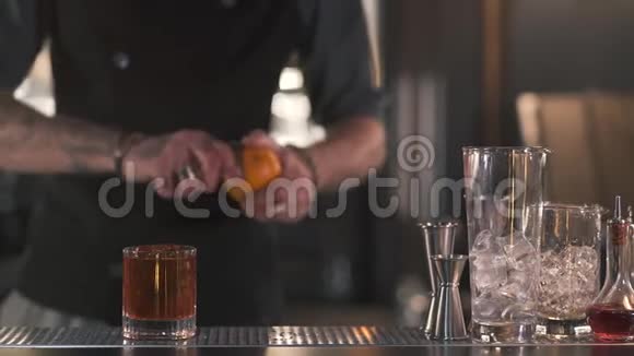 无法辨认的酒保切断了橙色的热情使一个清爽的酒精鸡尾酒站在酒吧柜台上视频的预览图