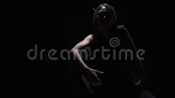 神秘的女人在黑暗中的形状姿势黑色的背景视频的预览图