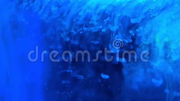 蓝色油漆油墨在玻璃上缓慢地流动随着墨水滴落和抽象烟雾爆炸视频的预览图