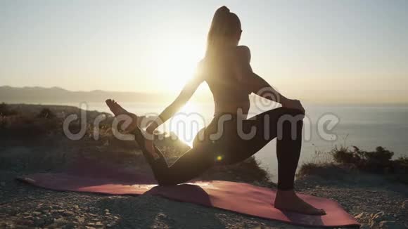 做瑜伽运动的女性剪影在阳光下伸展动作缓慢视频的预览图