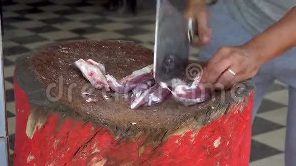 一个男人正在用一只羊的新鲜肉切割有人把骨头炸了视频的预览图